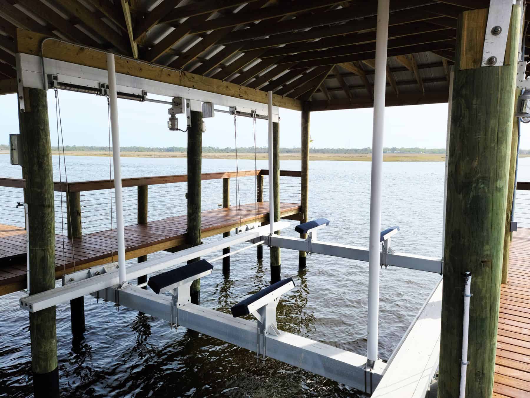 Boat lift cradle and beams under a covered dock